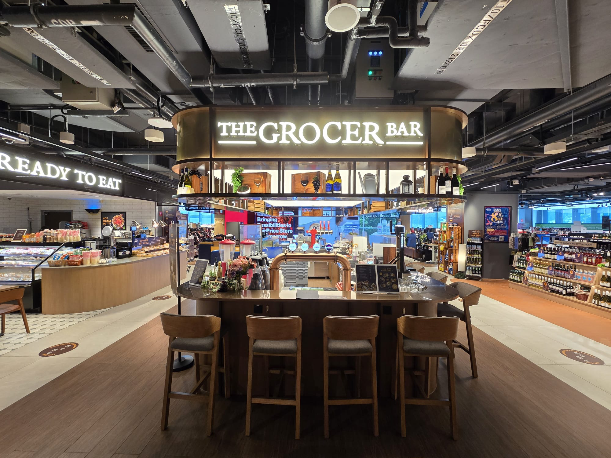 The Grocer Bar at FairPrice Finest Punggol Coast beside a Ready to Eat section.
